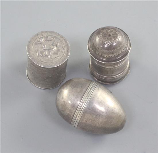 An early 19th century silver domed top nutmeg grater by Joseph Wilmore, an egg shaped nutmeg grater and a Chinese wite metal box,